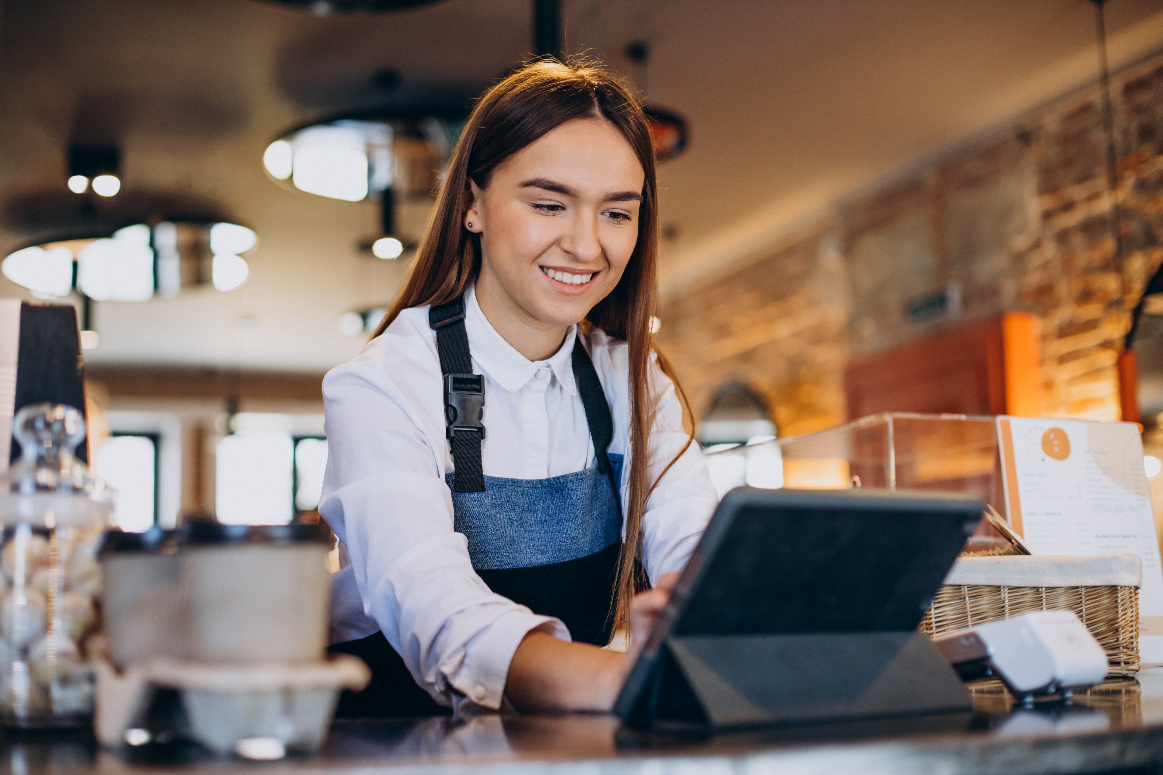 female-barista-with-tablet-making-order-coffee-shop